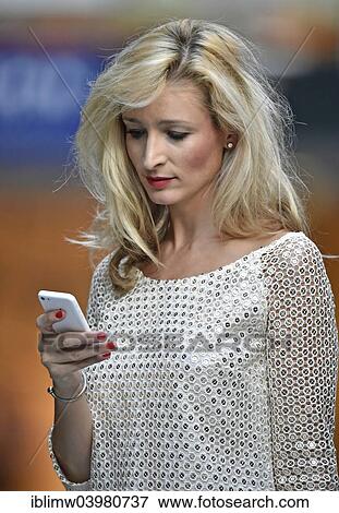 "Young woman using a mobile phone, Stuttgart, Baden-Wurttemberg, Germany, Europe" View Large Photo Image Stock Photo - "Young woman using a mobile phone, Stuttgart, Baden-Wurttemberg, Germany, Europe". Fotosearch