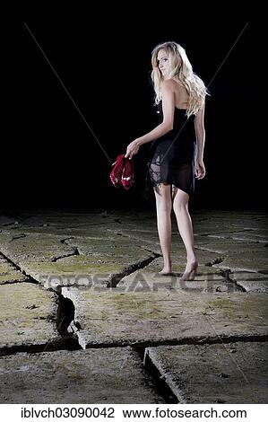 "Young woman walking barefoot in an evening dress across cracked clay, Schwaz, Schwaz District, North Tirol, Tirol, Austria, Europe" View Large Photo Image Stock Image - "Young woman walking barefoot in an evening dress across cracked clay, Schwaz, Schwaz District, North Tirol, Tirol, Austria, Europe". Fotosearch