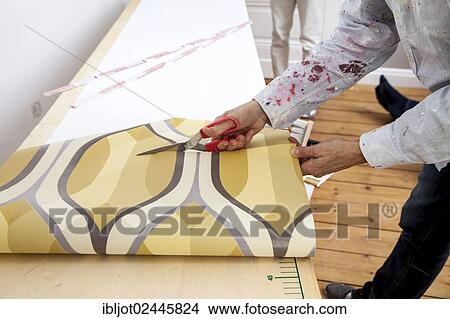 Young woman wallpapering a wall View Large Photo Image Picture - Young woman wallpapering a wall. Fotosearch