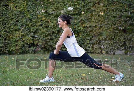 Stock Photo - "Young woman warming up, stretching exercises, Stuttgart, Baden-Wuerttemberg, Germany, Europe, PublicGround, Europe". Fotosearch