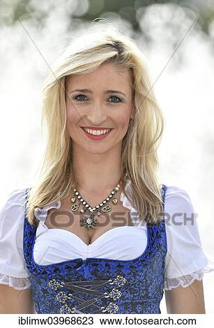 "Young woman wearing a blue dirndl, portrait" View Large Photo Image Stock Image - "Young woman wearing a blue dirndl, portrait". Fotosearch