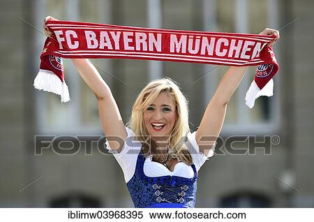 "Young woman wearing a dirndl, supporter of FC Bayern, holding up a fan scarf, Germany, Europe" View Large Photo Image Stock Photography - "Young woman wearing a dirndl, supporter of FC Bayern, holding up a fan scarf, Germany, Europe". Fotosearch