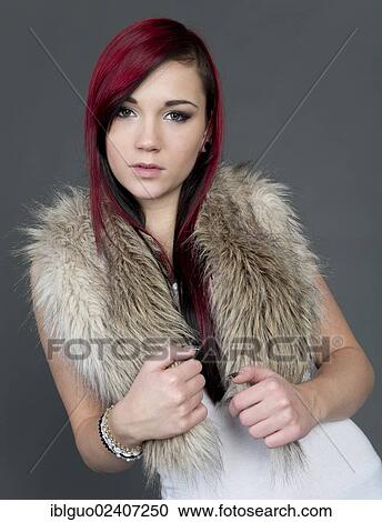 Stock Image - Young woman wearing a fake fur scarf. Fotosearch