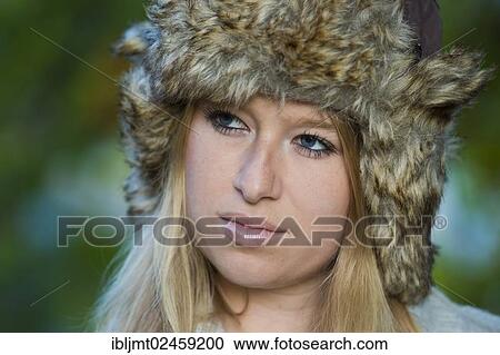 "Young woman wearing a fur hat and looking pensive, portrait" View Large Photo Image Stock Image - "Young woman wearing a fur hat and looking pensive, portrait". Fotosearch