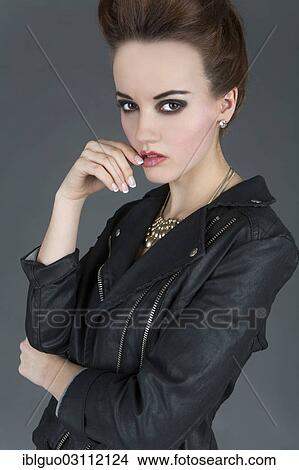 "Young woman wearing a leather outfit, fashion" View Large Photo Image Picture - "Young woman wearing a leather outfit, fashion". Fotosearch
