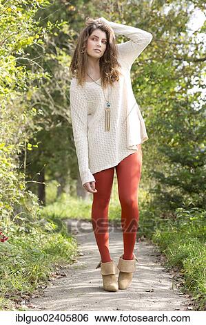 "Young woman wearing a long white sweater and red tights, outdoors" View Large Photo Image Stock Photograph - "Young woman wearing a long white sweater and red tights, outdoors". Fotosearch