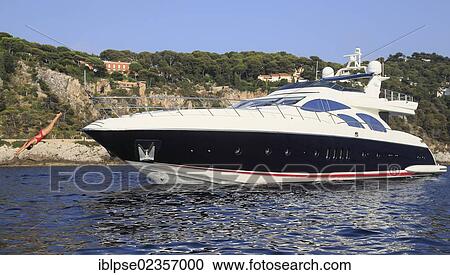 "Young woman wearing a red swimsuit making a swan dive from the bow of a motor yacht, French Riviera, Cote d'Azur, Mediterranean Sea, Europe" View Large Photo Image Stock Image - "Young woman wearing a red swimsuit making a swan dive from the bow of a motor yacht, French Riviera, Cote d'Azur, Mediterranean Sea, Europe". Fotosearch