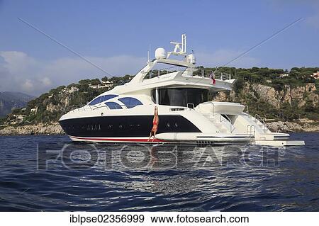 "Young woman wearing a red swimsuit making a swan dive from the rear deck of a motor yacht, French Riviera, Cote d'Azur, Mediterranean Sea, Europe" View Large Photo Image Stock Photo - "Young woman wearing a red swimsuit making a swan dive from the rear deck of a motor yacht, French Riviera, Cote d'Azur, Mediterranean Sea, Europe". Fotosearch