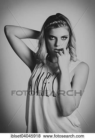 Stock Photo - "Young woman wearing a top with the word """"angel""""". Fotosearch