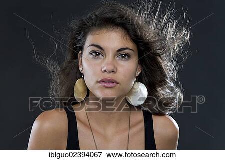 "Young woman wearing large earrings, portrait" View Large Photo Image Stock Photo - "Young woman wearing large earrings, portrait". Fotosearch