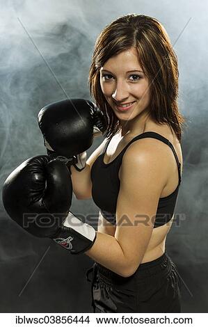Young woman wearing sportswear and boxing gloves View Large Photo Image Picture - Young woman wearing sportswear and boxing gloves. Fotosearch