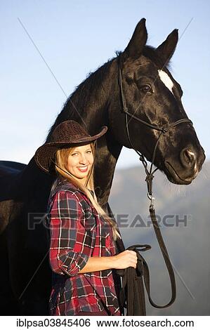 "Young woman with a black Hanoverian horse, North Tyrol, Austria, Europe" View Large Photo Image Stock Photograph - "Young woman with a black Hanoverian horse, North Tyrol, Austria, Europe". Fotosearch