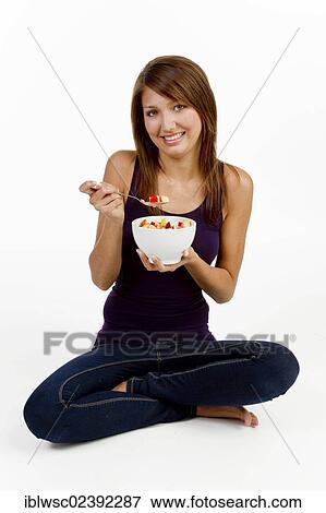 Young woman with a bowl of cereal View Large Photo Image Stock Photo - Young woman with a bowl of cereal. Fotosearch