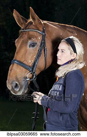 "Young woman with a bridled Hanoverian, chestnut horse with white spots, pigmentation disorder, Austria, Europe" View Large Photo Image Stock Photography - "Young woman with a bridled Hanoverian, chestnut horse with white spots, pigmentation disorder, Austria, Europe". Fotosearch