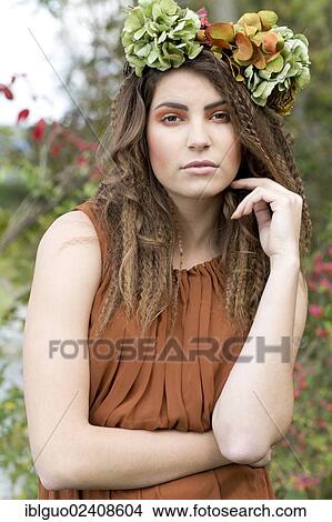 "Young woman with a flowal wreath in her hair, outdoors, portrait" View Large Photo Image Picture - "Young woman with a flowal wreath in her hair, outdoors, portrait". Fotosearch