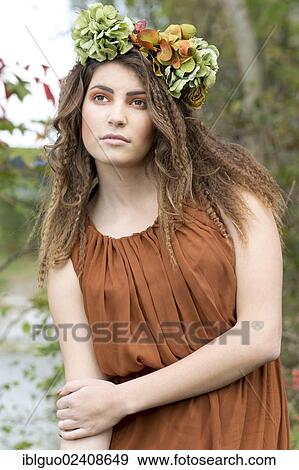 "Young woman with a flowal wreath in her hair, outdoors" View Large Photo Image Stock Photo - "Young woman with a flowal wreath in her hair, outdoors". Fotosearch