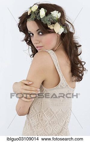 Young woman with a flower arrangement as a headdress View Large Photo Image Picture - Young woman with a flower arrangement as a headdress. Fotosearch