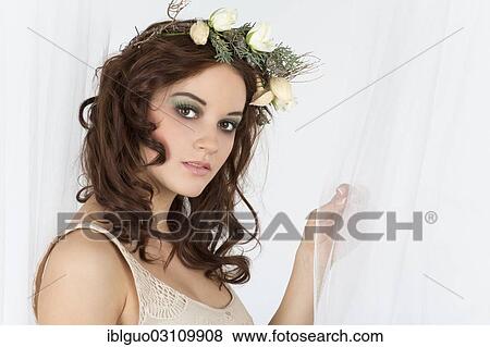 Young woman with a flower arrangement as a headdress View Large Photo Image Stock Photo - Young woman with a flower arrangement as a headdress. Fotosearch