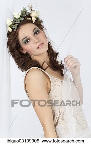 Stock Photograph - Young woman with a flower arrangement as a headdress. Fotosearch