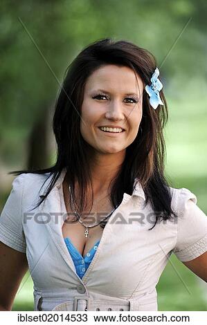 Stock Image - "Young woman with a flower in her hair, portrait". Fotosearch