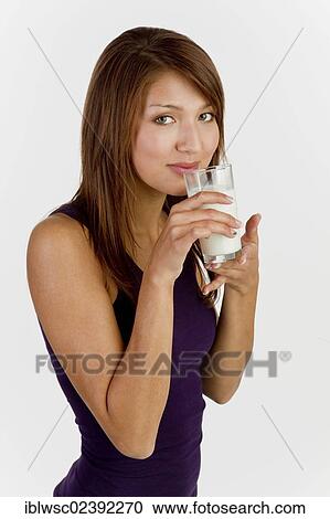 Stock Image - Young woman with a glass of milk. Fotosearch