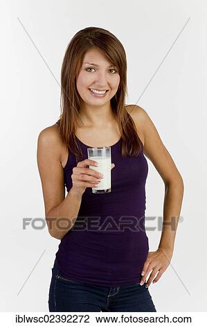 Young woman with a glass of milk View Large Photo Image Stock Image - Young woman with a glass of milk. Fotosearch
