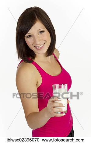 Stock Image - "Young woman with a glass of milk, smiling". Fotosearch