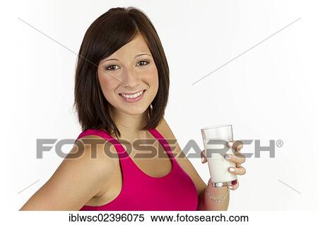 "Young woman with a glass of milk, smiling" View Large Photo Image Stock Photography - "Young woman with a glass of milk, smiling". Fotosearch
