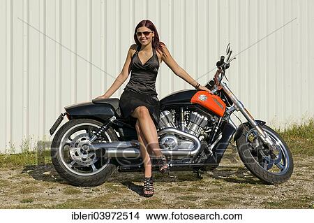 Young woman with a motorcycle View Large Photo Image Picture - Young woman with a motorcycle. Fotosearch