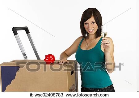 "Young woman with a moving box, a piggy bank and a glass of champagne in her hand" View Large Photo Image Stock Image - "Young woman with a moving box, a piggy bank and a glass of champagne in her hand". Fotosearch