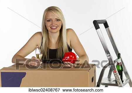 Stock Photo - Young woman with a piggy bank and a moving box. Fotosearch