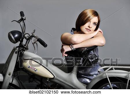 Young woman with a vintage Motom motorcycle View Large Photo Image Stock Image - Young woman with a vintage Motom motorcycle. Fotosearch