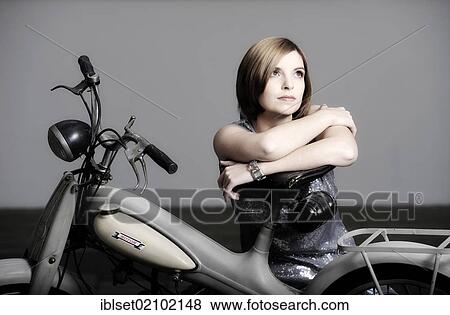 Young woman with a vintage Motom motorcycle View Large Photo Image Stock Photo - Young woman with a vintage Motom motorcycle. Fotosearch