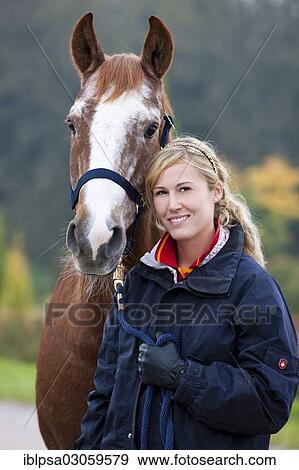 "Young woman with an Austrian Warmblood, chestnut horse" View Large Photo Image Stock Photo - "Young woman with an Austrian Warmblood, chestnut horse". Fotosearch