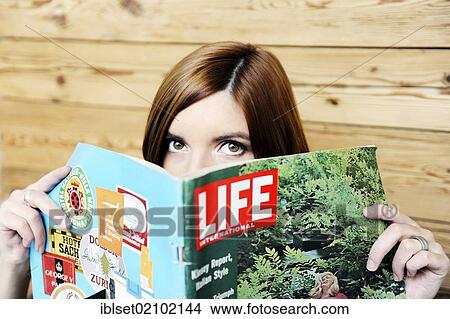 Young woman with an old Life magazine View Large Photo Image Picture - Young woman with an old Life magazine. Fotosearch