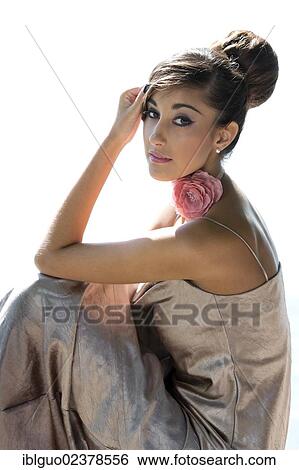 Young Woman With An Updo Hairstyle And A Long Silvery Evening