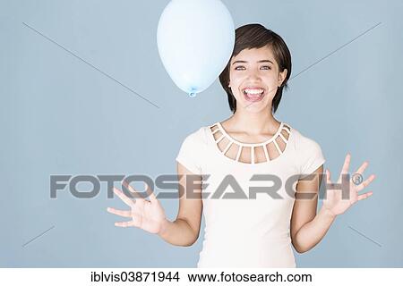 Young woman with blue balloon View Large Photo Image Picture - Young woman with blue balloon. Fotosearch