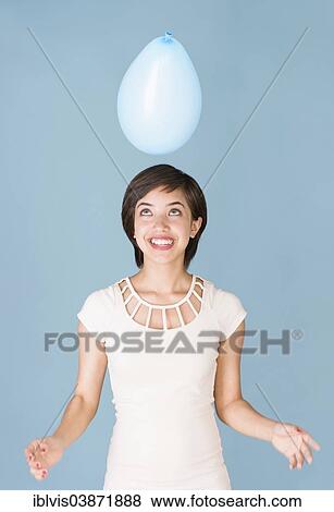 Young woman with blue balloon View Large Photo Image Stock Photo - Young woman with blue balloon. Fotosearch