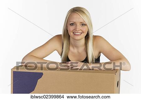 Picture - Young woman with boxes for moving house. Fotosearch