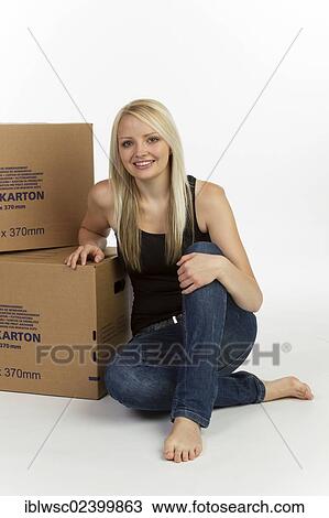 Young woman with boxes for moving house View Large Photo Image Stock Image - Young woman with boxes for moving house. Fotosearch