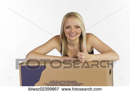 Stock Photo - Young woman with boxes for moving house. Fotosearch
