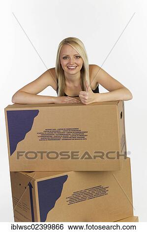 Young woman with boxes for moving house View Large Photo Image Stock Photograph - Young woman with boxes for moving house. Fotosearch