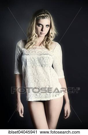 Stock Image - Young woman with braided hair wearing a lace top. Fotosearch