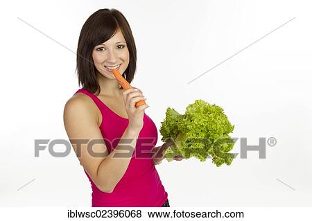 Young woman with carrot and lettuce View Large Photo Image Stock Photo - Young woman with carrot and lettuce. Fotosearch