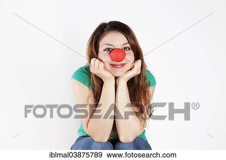 Young woman with clown nose View Large Photo Image Stock Photo - Young woman with clown nose. Fotosearch