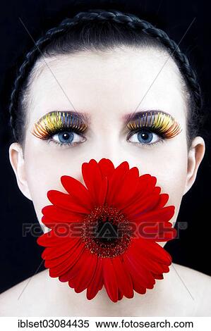 "Young woman with colourful eyelashes and a red flower in her mouth, Austria, Europe" View Large Photo Image Stock Photography - "Young woman with colourful eyelashes and a red flower in her mouth, Austria, Europe". Fotosearch