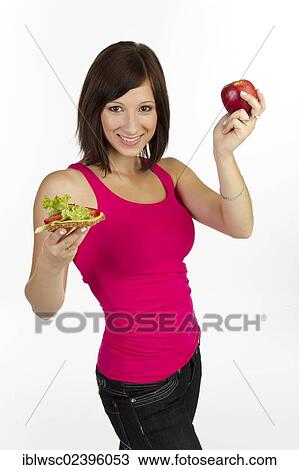 "Young woman with grain bread topped with cheese and tomato, an apple in the other hand" View Large Photo Image Stock Image - "Young woman with grain bread topped with cheese and tomato, an apple in the other hand". Fotosearch