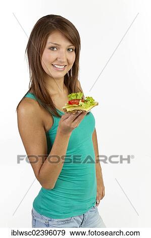 "Young woman with grain bread topped with cheese and tomato, smiling" View Large Photo Image Stock Photo - "Young woman with grain bread topped with cheese and tomato, smiling". Fotosearch