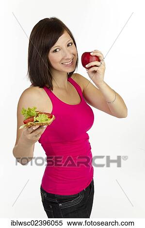 "Young woman with grain bread topped with cheese and tomato, an apple in the other hand" View Large Photo Image Stock Photography - "Young woman with grain bread topped with cheese and tomato, an apple in the other hand". Fotosearch