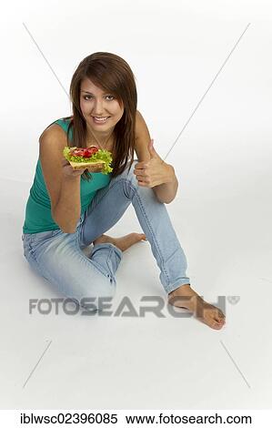 "Young woman with grain bread topped with cheese and tomato, thumbs-up" View Large Photo Image Stock Photography - "Young woman with grain bread topped with cheese and tomato, thumbs-up". Fotosearch
